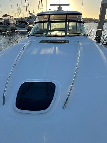 Slide: The Image of 2005 Sea Ray 420 Sundancer yacht docked at sunset, showcasing sleek design and spacious deck. - 12