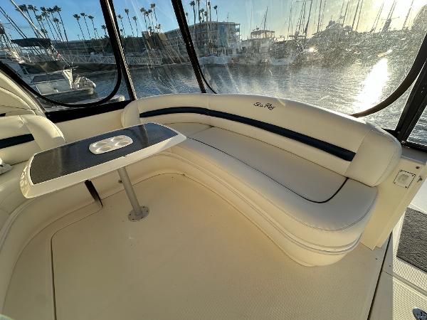 Slide: The Image of Luxurious 2005 Sea Ray 420 Sundancer interior with elegant seating and table, marina view. - 17