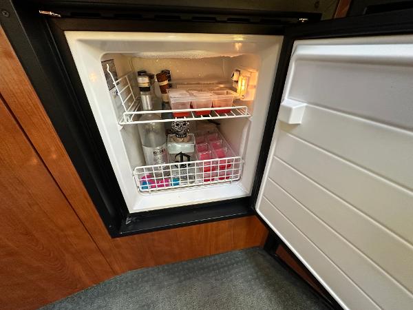 Slide: The Image of Mini fridge stocked with beverages and snacks on a 2005 Sea Ray 420 Sundancer yacht. - 41