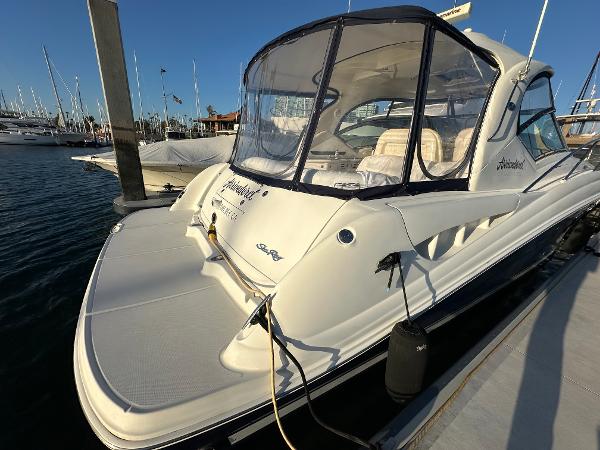 Slide: The Image of 2005 Sea Ray 420 Sundancer docked at marina, featuring sleek design and spacious deck. - 6