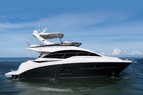 Slide: The Image of 2015 Sea Ray 510 Fly yacht cruising on open water under clear skies. - 0