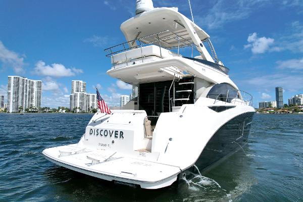 Slide: The Image of Luxury 2015 Sea Ray 510 Fly yacht cruising in sunny waters, city skyline in background. - 1