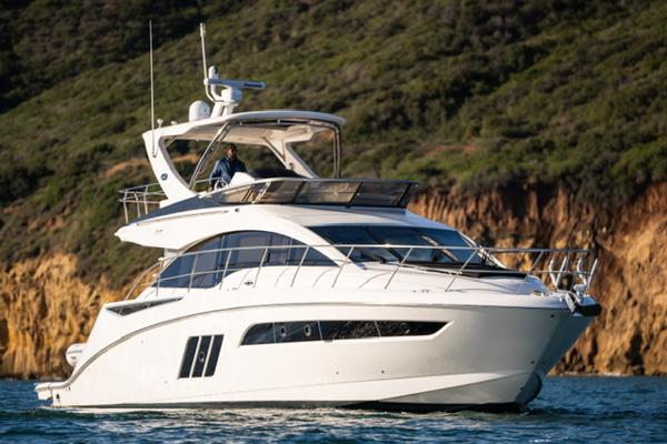 Slide: The Image of 2015 Sea Ray 510 Fly yacht cruising near rocky coastline. - 1