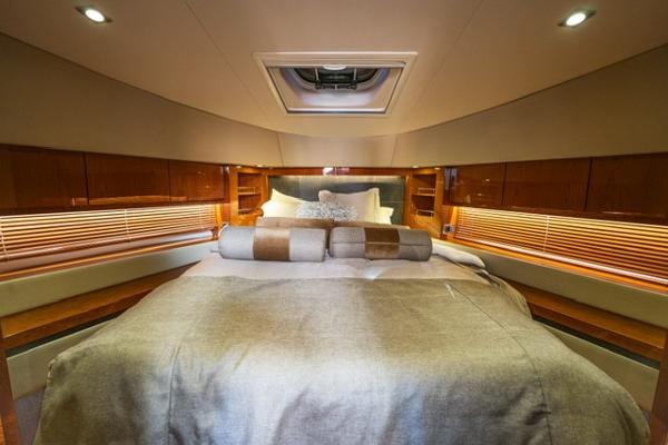 Slide: The Image of Luxurious bedroom interior of 2015 Sea Ray 510 Fly yacht with elegant bedding and wood accents. - 17