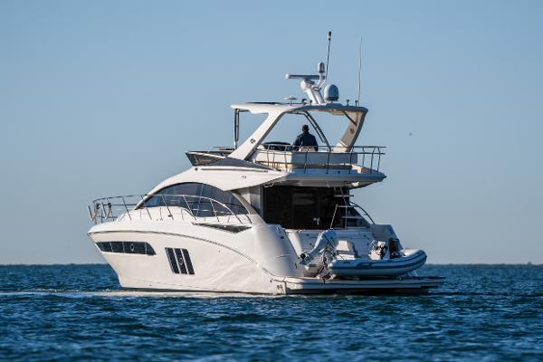 Slide: The Image of 2015 Sea Ray 510 Fly yacht cruising on open water. - 27