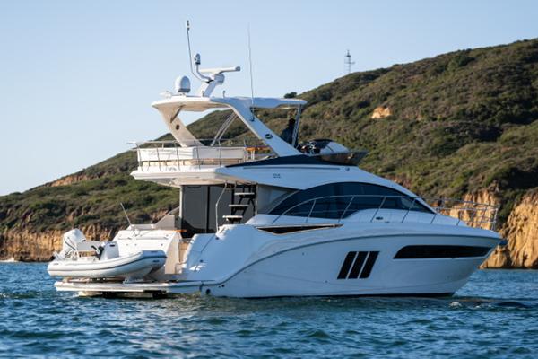 Slide: The Image of 2015 Sea Ray 510 Fly yacht on water near rocky coastline. - 28