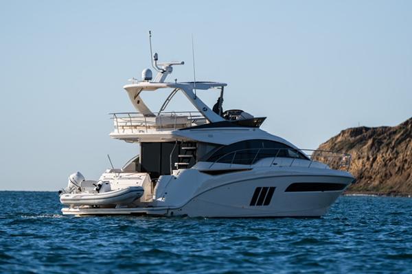 Slide: The Image of 2015 Sea Ray 510 Fly yacht cruising near rocky coastline. - 32