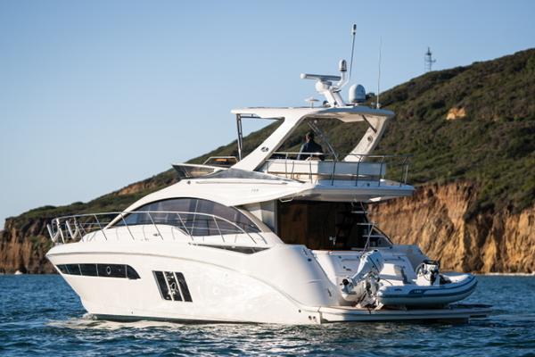 Slide: The Image of 2015 Sea Ray 510 Fly yacht cruising near rocky coastline. - 35
