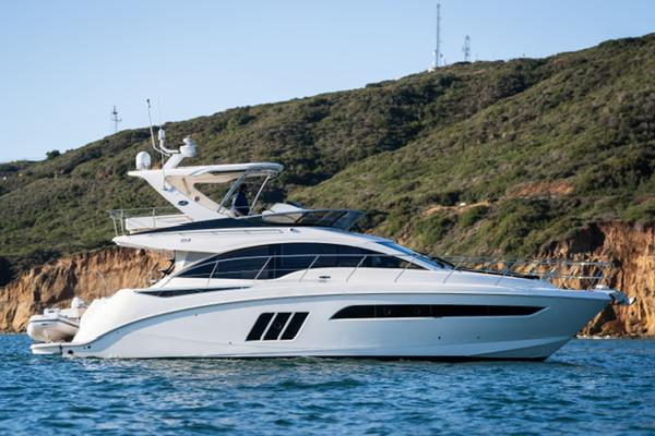 Slide: The Image of 2015 Sea Ray 510 Fly yacht cruising near rocky coastline. - 36