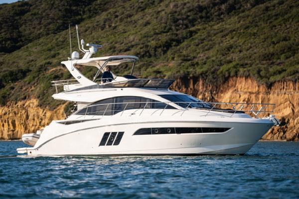 Slide: The Image of 2015 Sea Ray 510 Fly yacht cruising near rocky coastline. - 38