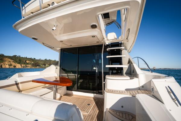 Slide: The Image of 2015 Sea Ray 510 Fly yacht deck with seating and stairs, ocean view. - 4