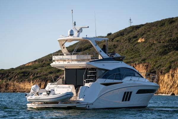 Slide: The Image of 2015 Sea Ray 510 Fly yacht cruising near rocky coastline. - 42