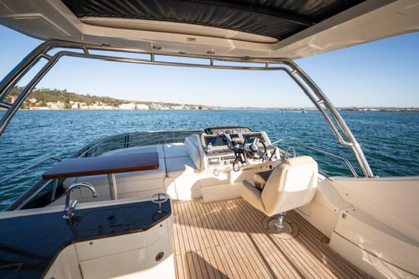 Slide: The Image of 2015 Sea Ray 510 Fly yacht helm with ocean view and modern controls. - 47