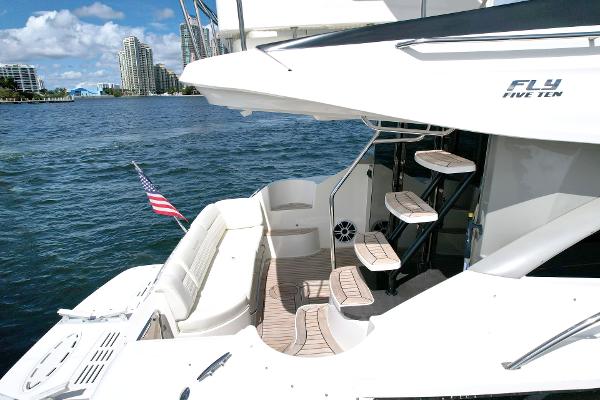 Slide: The Image of Luxurious 2015 Sea Ray 510 Fly yacht on serene water, featuring elegant deck and seating. - 9