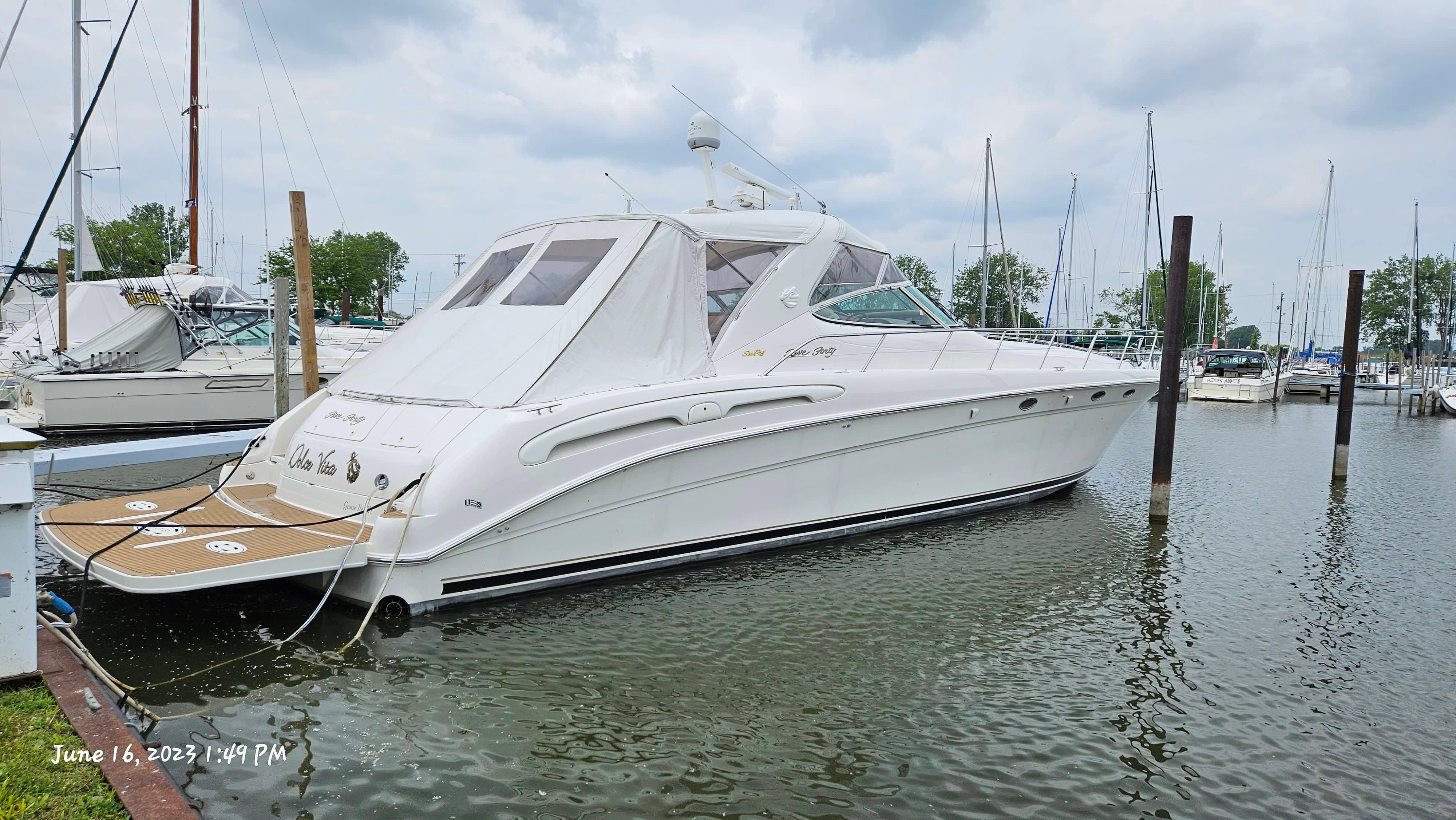 Slide: The Image of 1999 Sea Ray 540 Sundancer yacht docked at marina on June 16, 2023. - 0