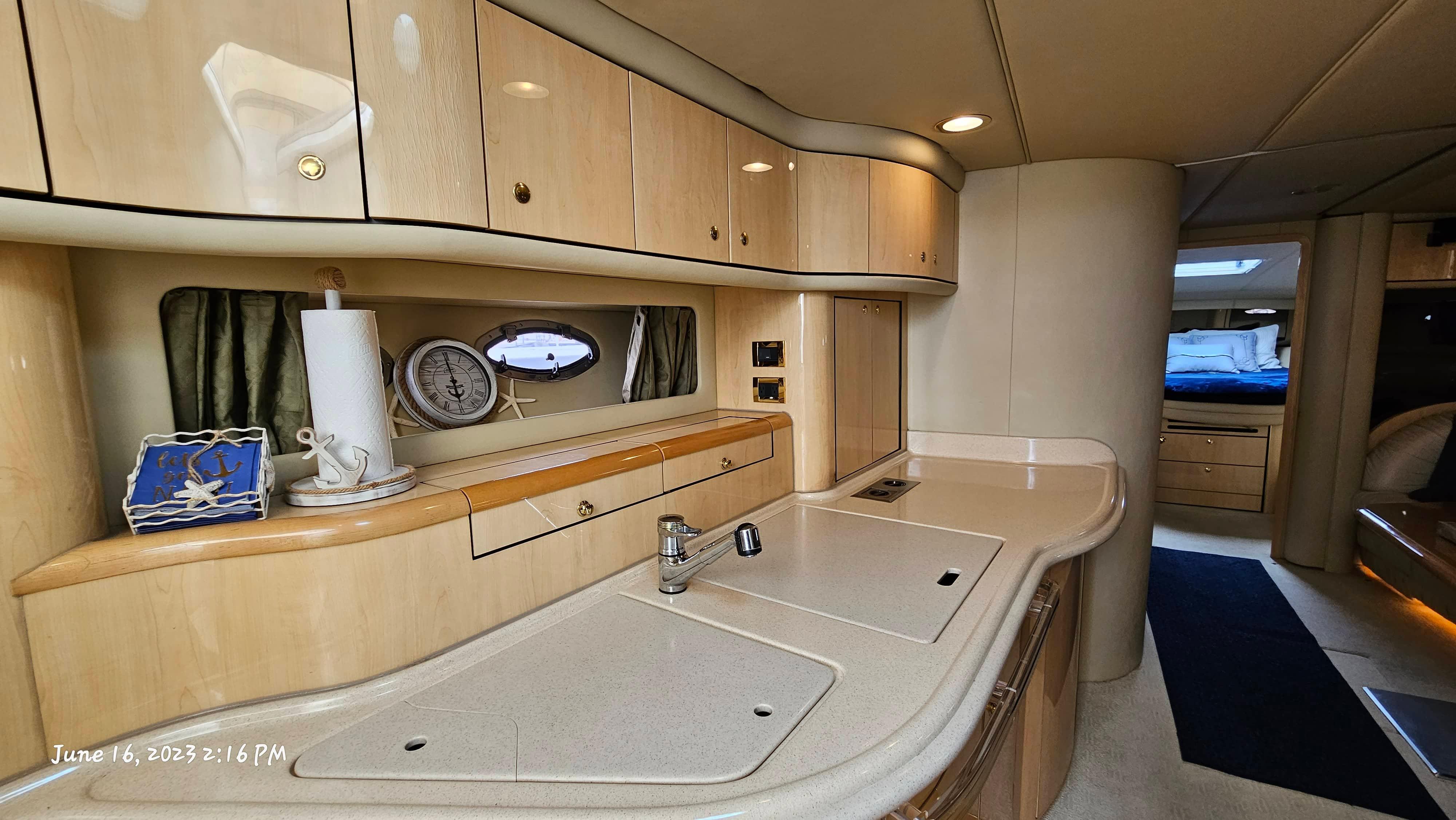Slide: The Image of Interior of 1999 Sea Ray 540 Sundancer yacht with modern kitchen and cozy bedroom. - 13