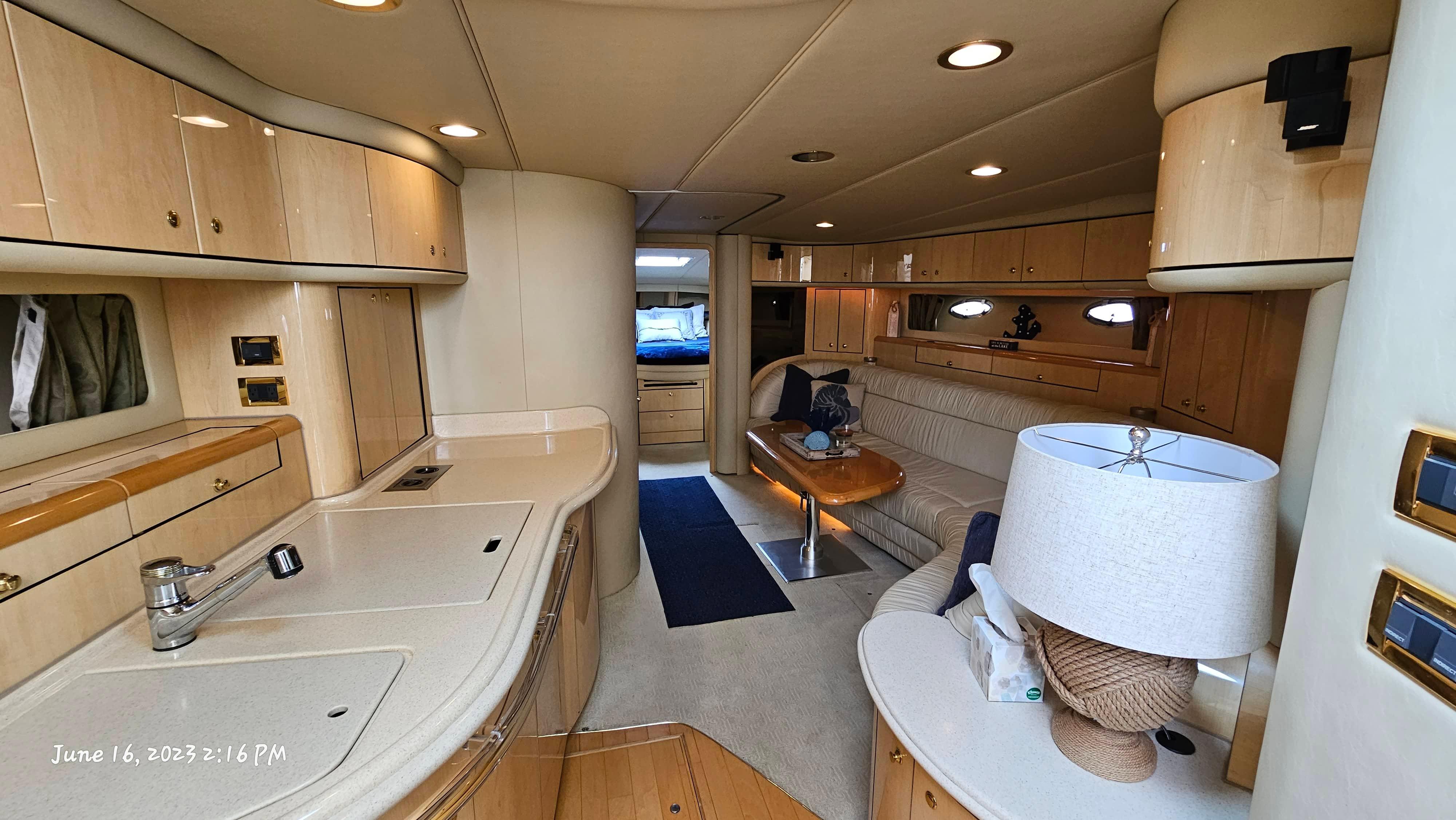 Slide: The Image of Interior of 1999 Sea Ray 540 Sundancer yacht with modern kitchen and cozy living area. - 14