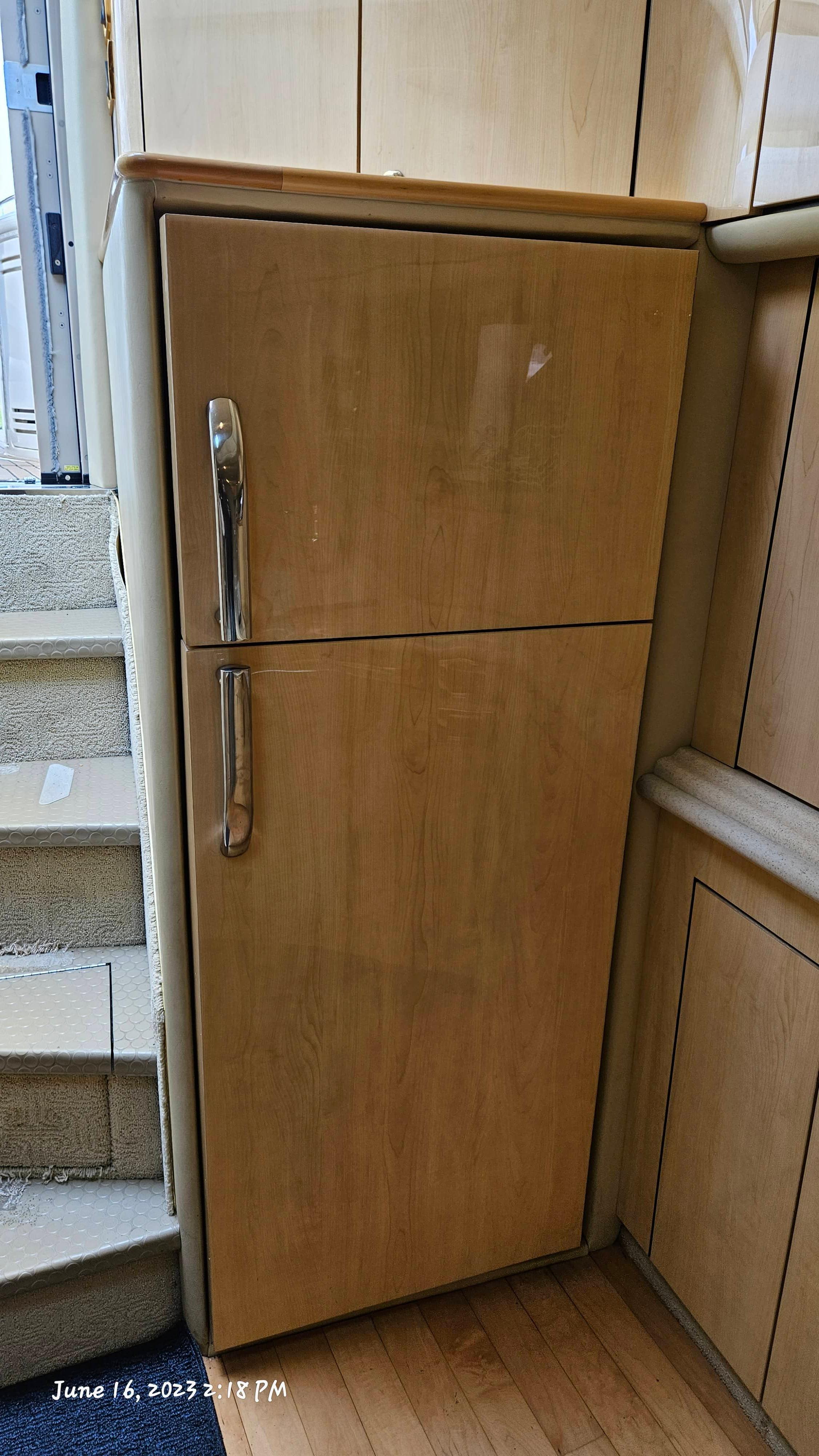 Slide: The Image of Wooden cabinetry and stairs inside a 1999 Sea Ray 540 Sundancer yacht. - 16