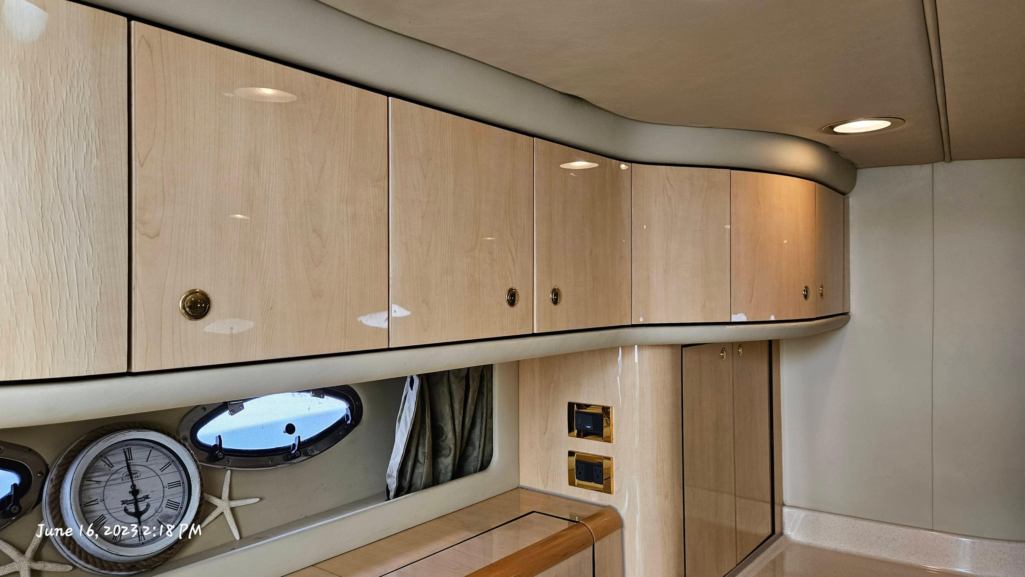 Slide: The Image of Interior of 1999 Sea Ray 540 Sundancer with wooden cabinets and nautical decor. - 18