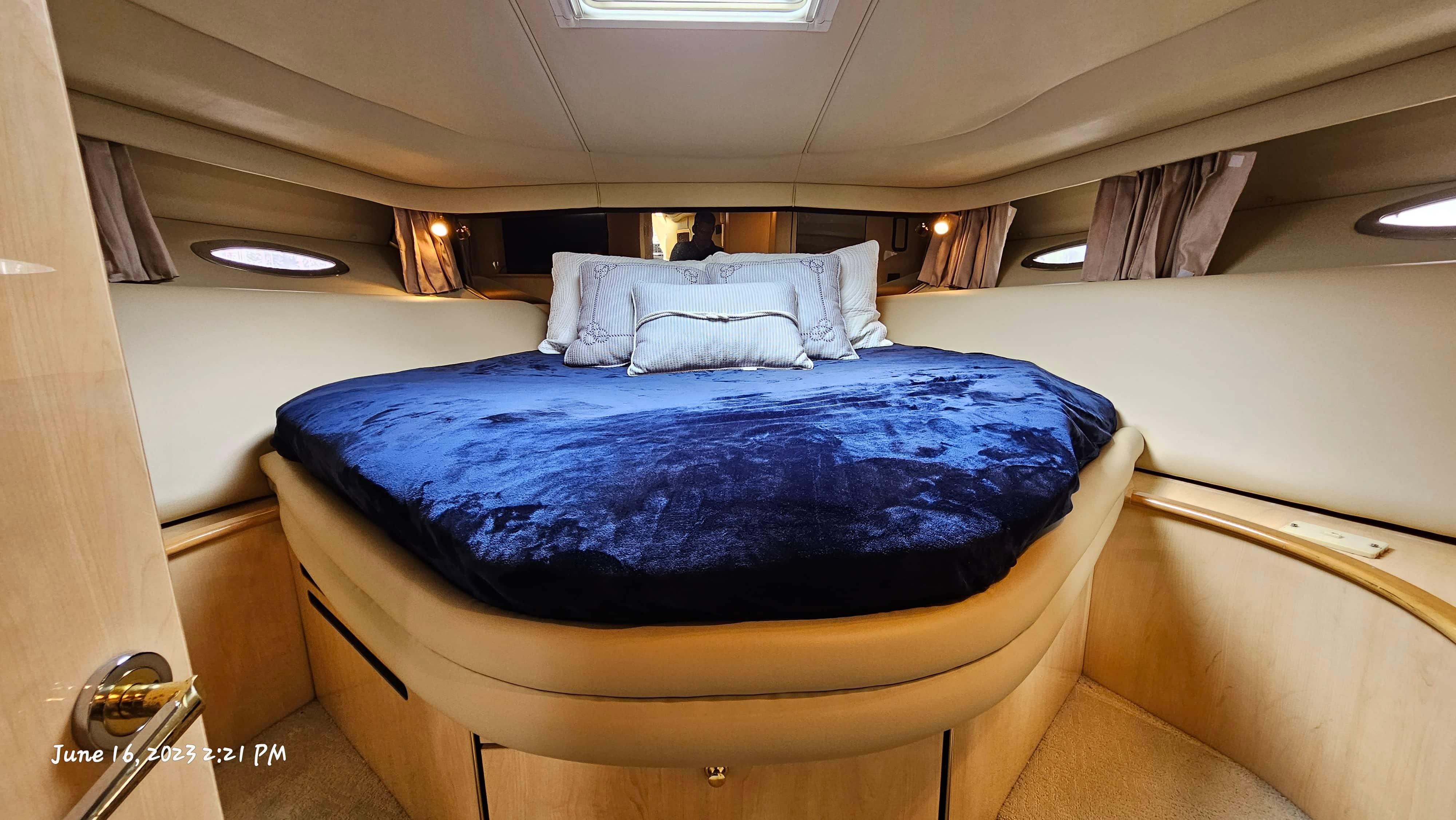 Slide: The Image of Luxurious bedroom interior of 1999 Sea Ray 540 Sundancer yacht with plush bedding. - 24