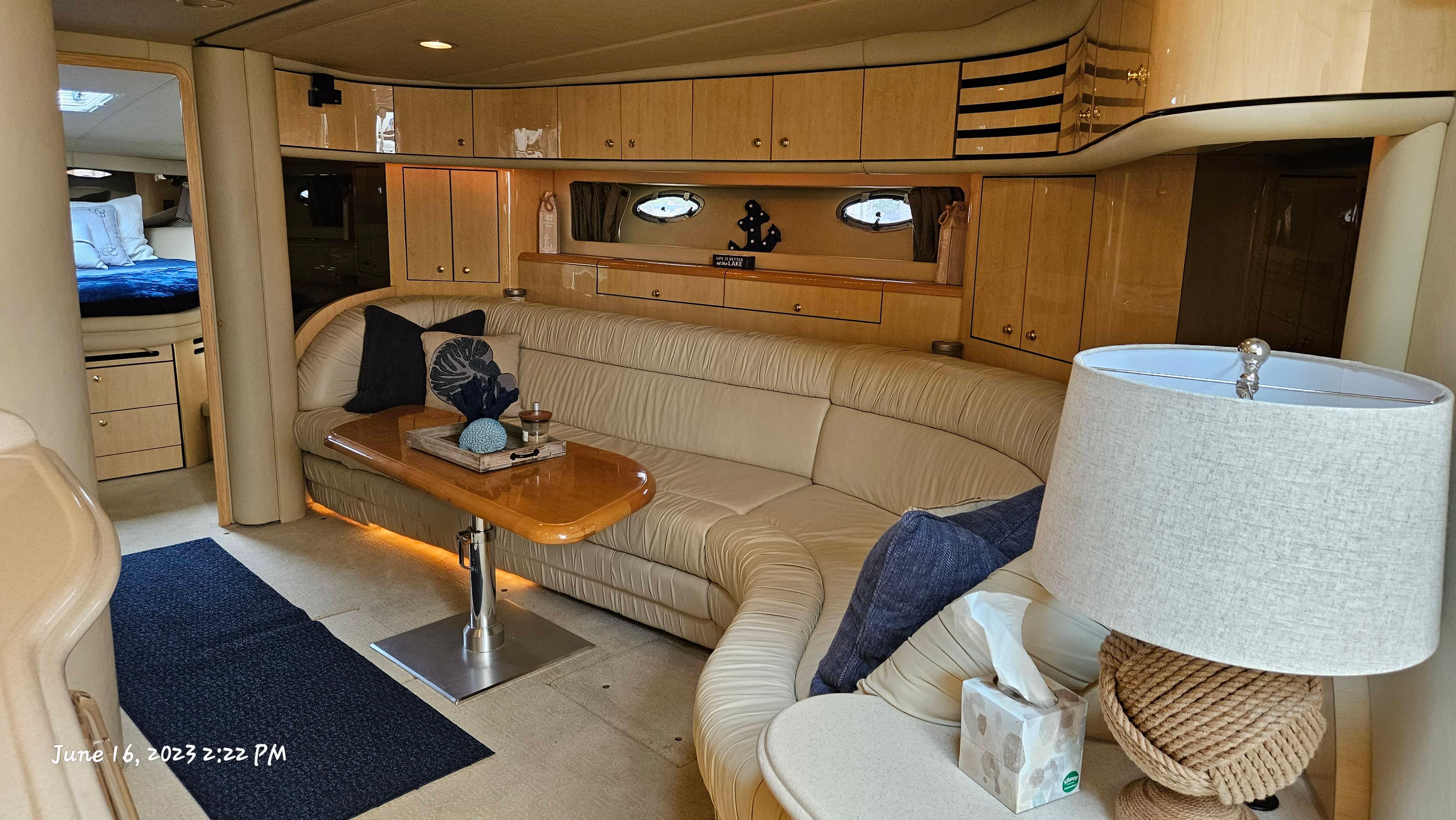 Slide: The Image of Interior of 1999 Sea Ray 540 Sundancer yacht with beige leather seating and wooden cabinetry. - 27
