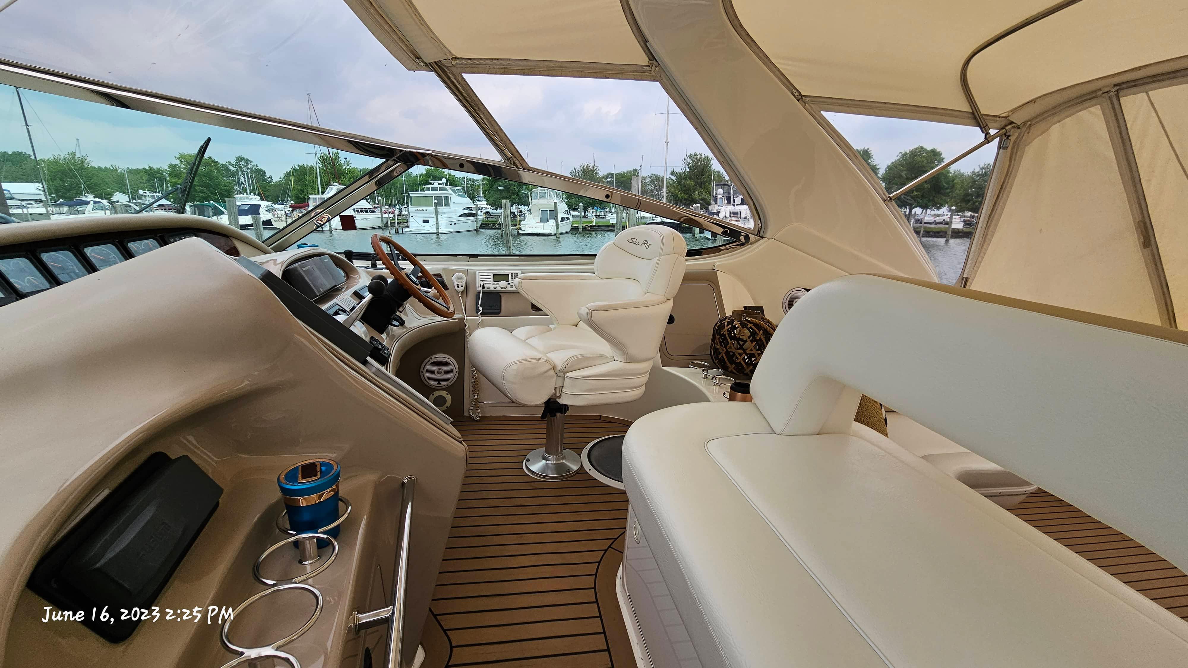 Slide: The Image of Interior of a 1999 Sea Ray 540 Sundancer yacht with white leather seating. - 30