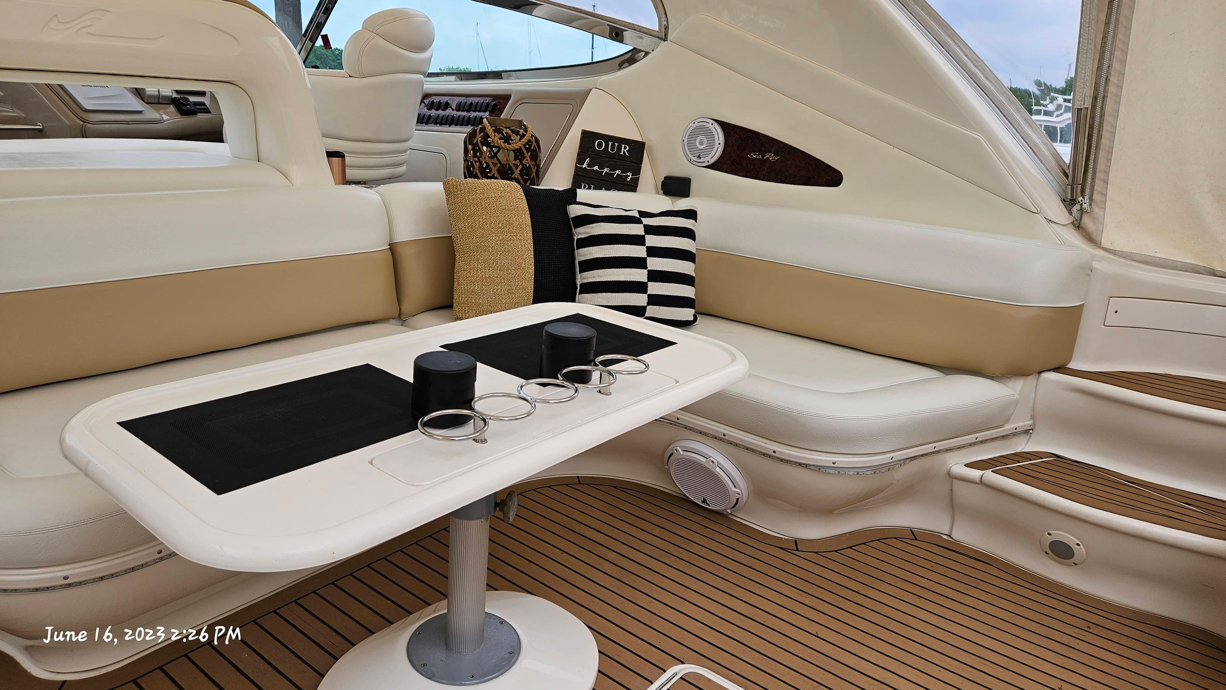 Slide: The Image of Interior of a 1999 Sea Ray 540 Sundancer yacht with seating and table. - 33