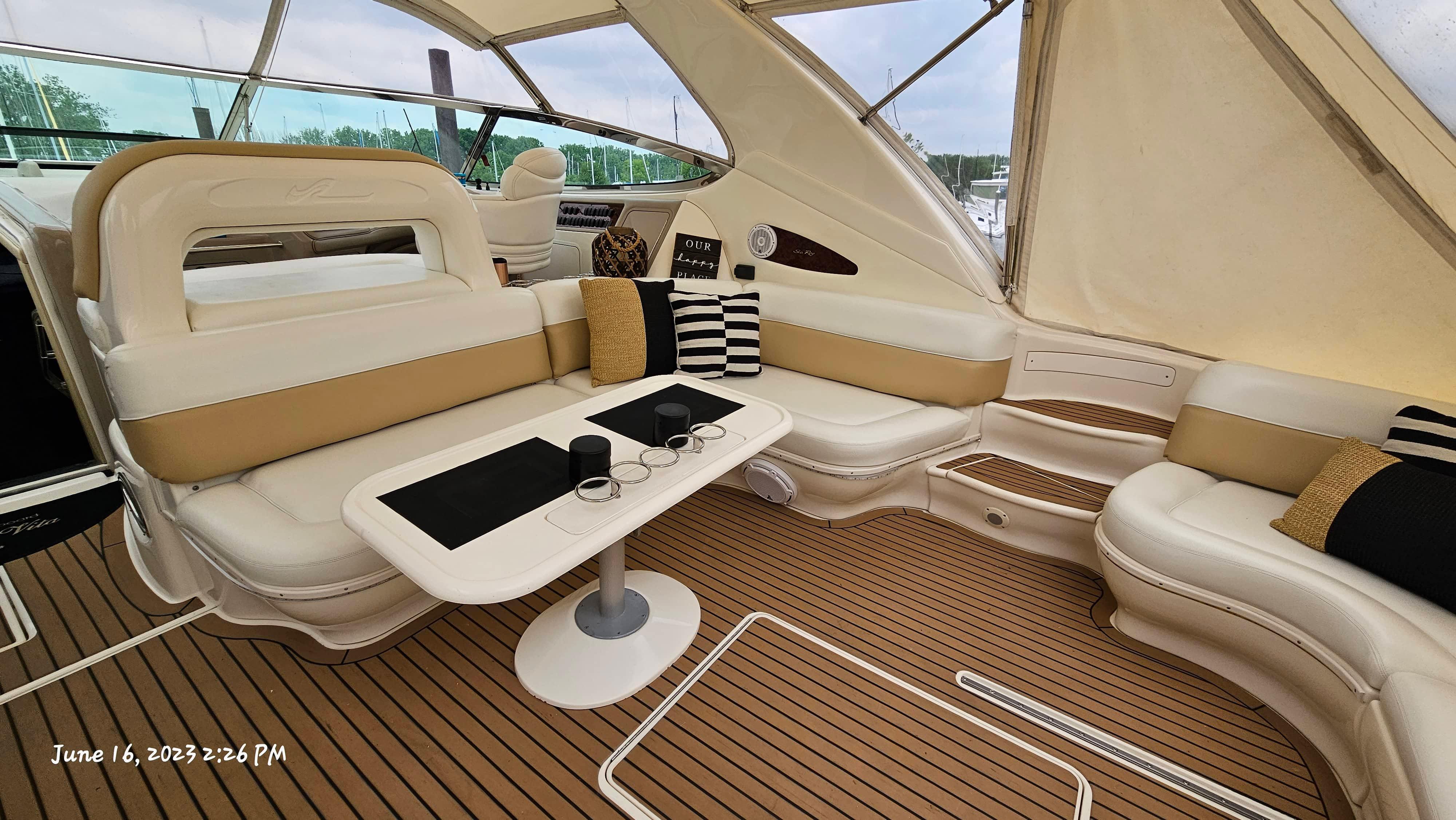 Slide: The Image of Interior of a 1999 Sea Ray 540 Sundancer yacht with seating and table. - 34