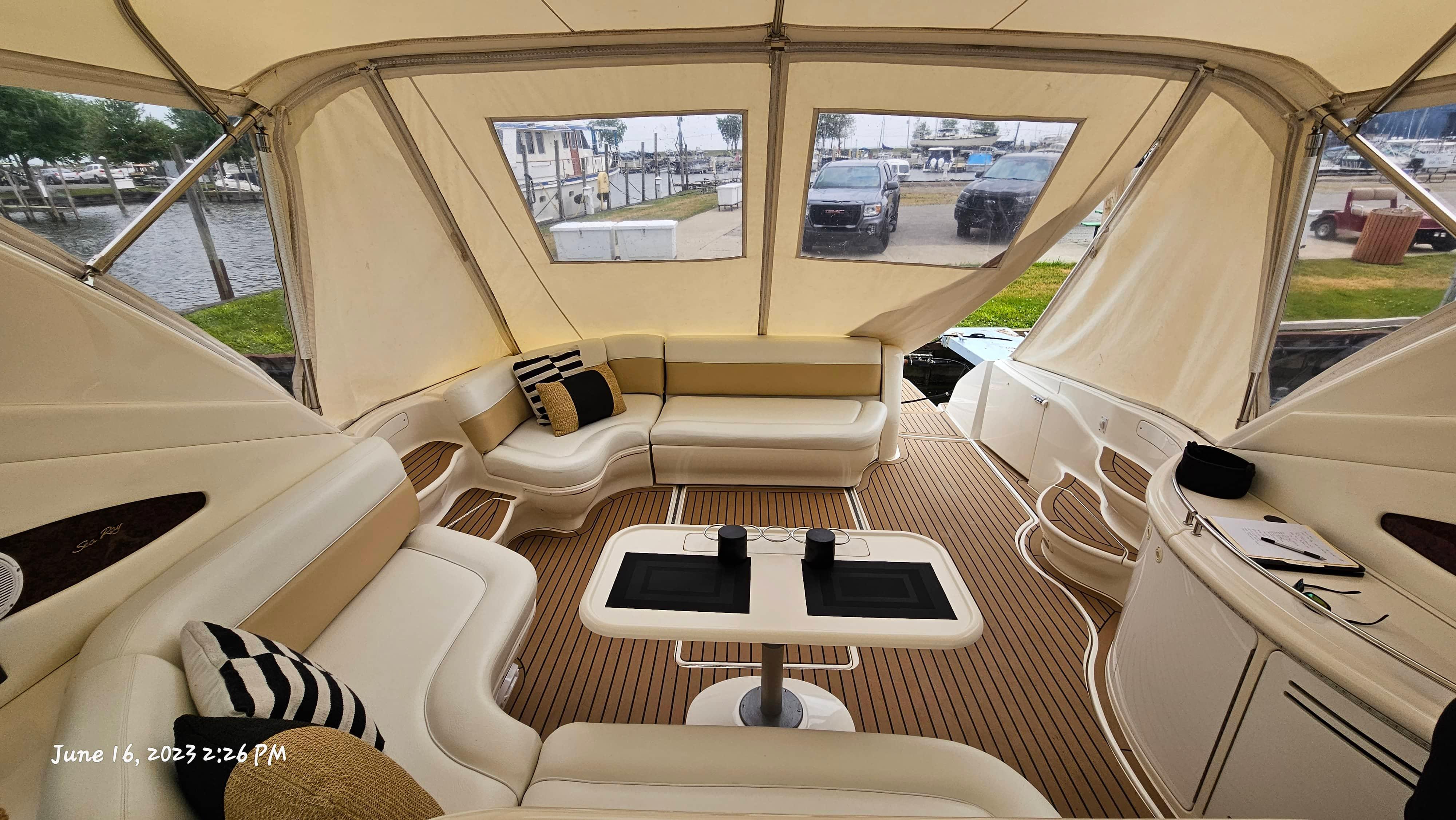 Slide: The Image of Interior of 1999 Sea Ray 540 Sundancer yacht with beige seating and wooden flooring. - 36