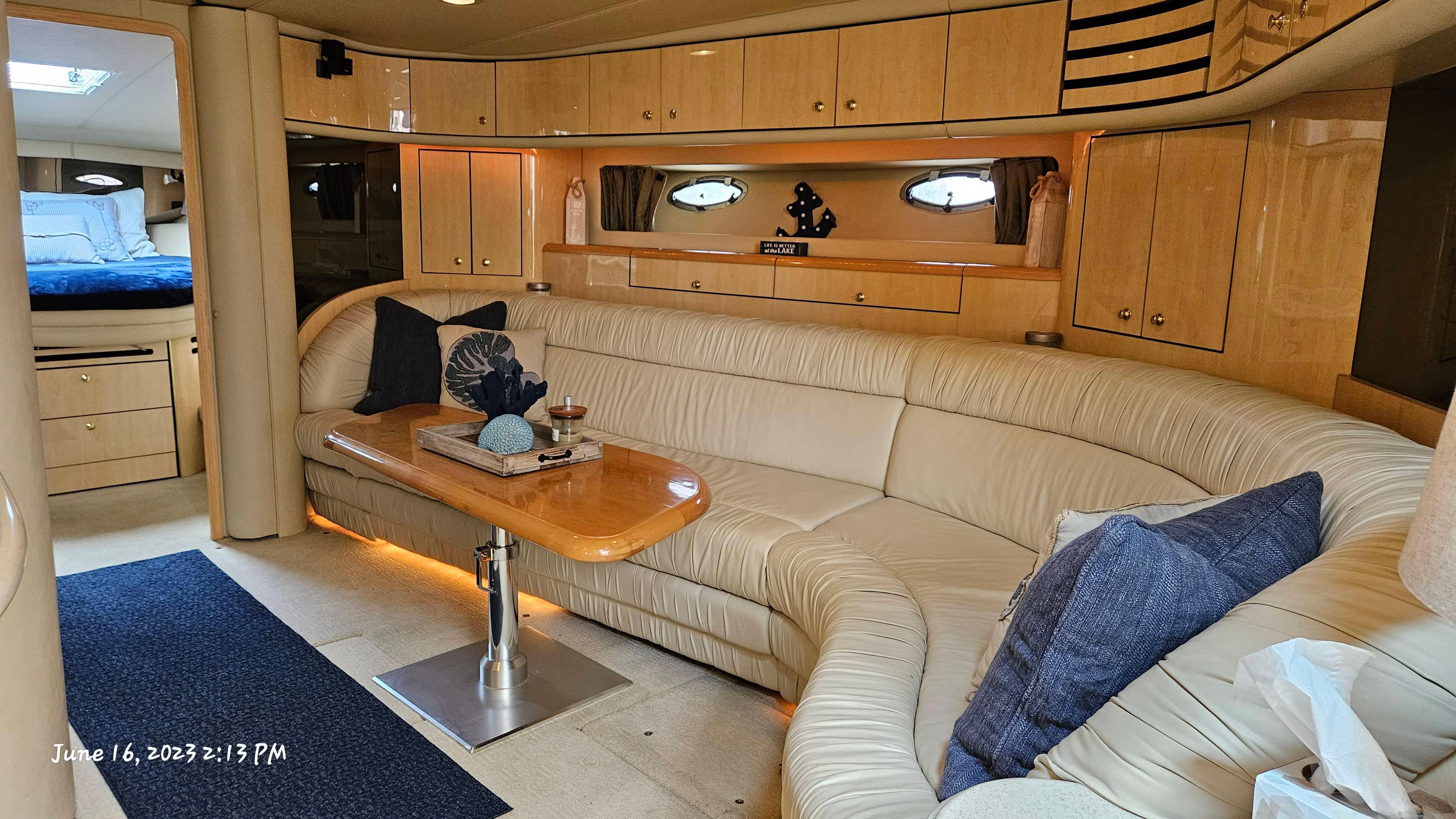 Slide: The Image of Luxurious interior of 1999 Sea Ray 540 Sundancer yacht with leather seating and wooden cabinetry. - 4