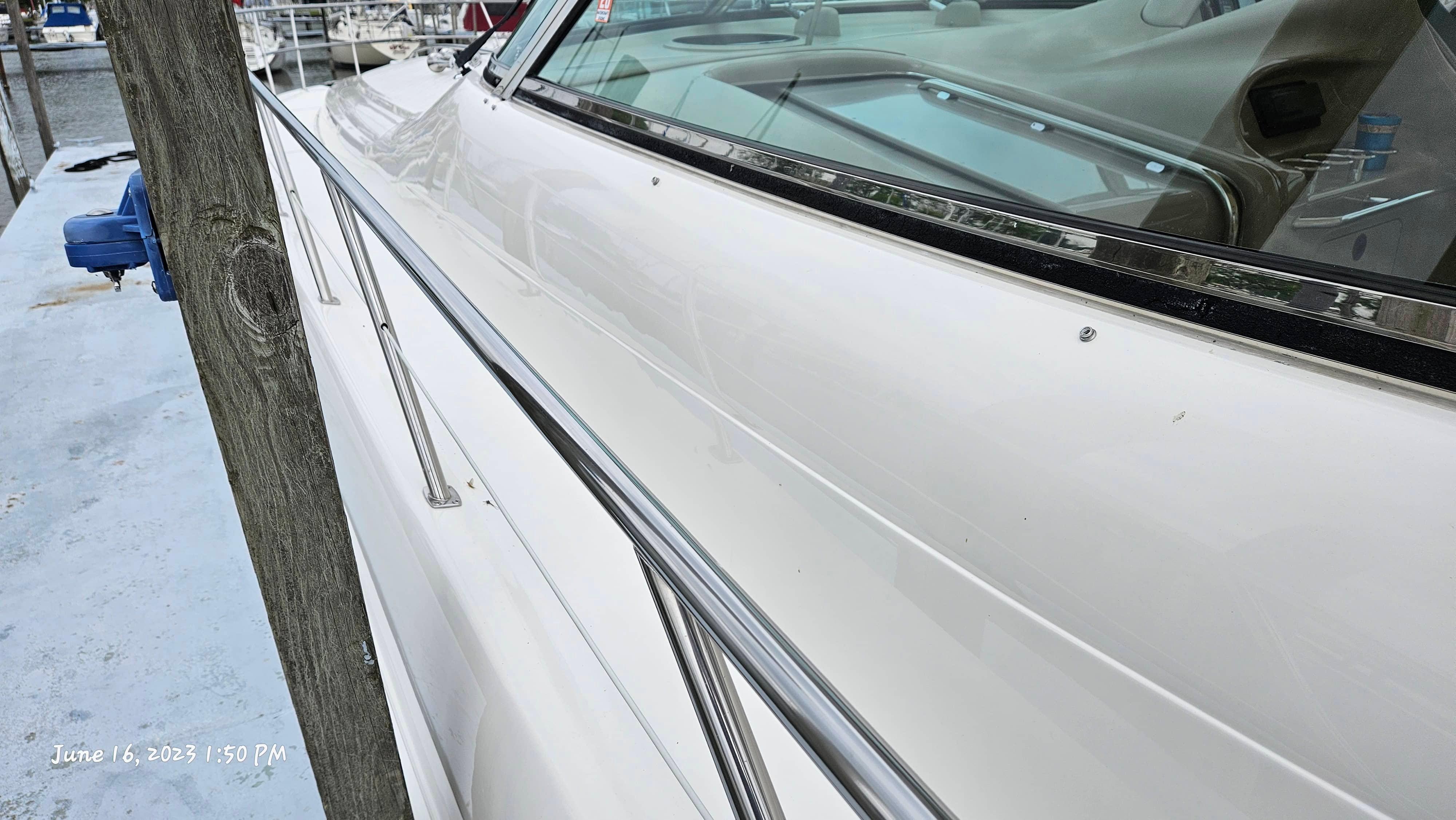 Slide: The Image of Side view of a 1999 Sea Ray 540 Sundancer yacht docked at a marina. - 6
