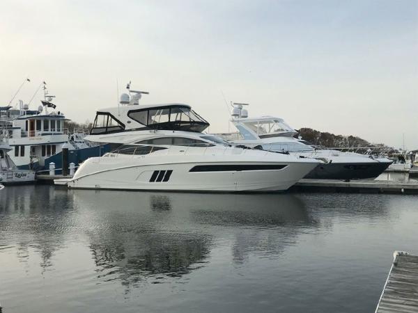 Slide: The Image of 2016 Sea Ray L590 Fly yacht docked at a marina. - 0