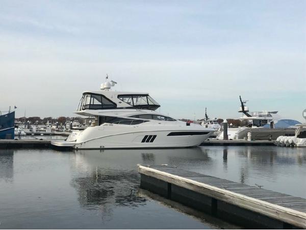 Slide: The Image of 2016 Sea Ray L590 Fly yacht docked at a marina. - 1