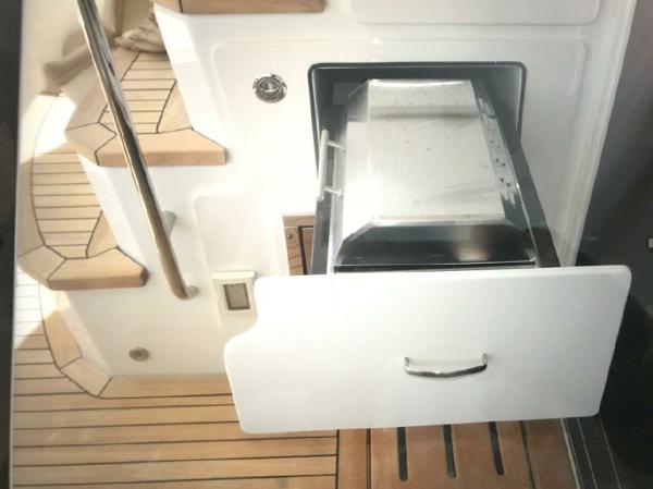 Slide: The Image of 2016 Sea Ray L590 Fly yacht interior with open drawer and wooden steps. - 3