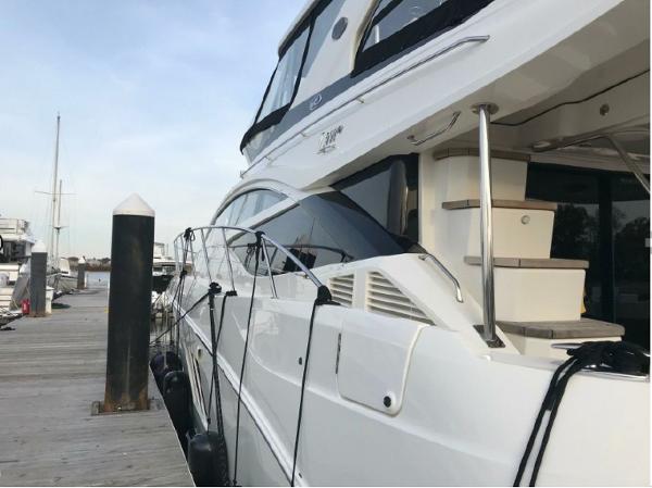 Slide: The Image of 2016 Sea Ray L590 Fly yacht docked at marina. - 4