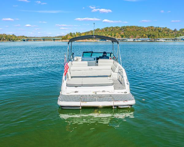 Slide: The Image of 2021 Sea Ray SDX 250 boat on a serene lake with clear skies. - 1