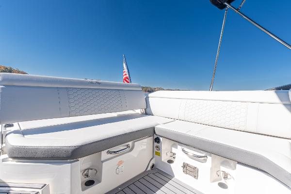 Slide: The Image of 2021 Sea Ray SDX 250 boat interior with white seating and American flag. - 12