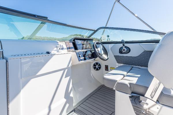 Slide: The Image of 2021 Sea Ray SDX 250 boat interior with steering wheel and seating. - 18