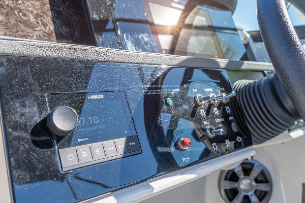 Slide: The Image of 2021 Sea Ray SDX 250 dashboard with control panel and audio system. - 20