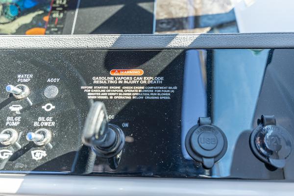 Slide: The Image of Control panel of 2021 Sea Ray SDX 250 boat with safety warning and switches. - 24