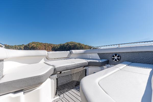 Slide: The Image of 2021 Sea Ray SDX 250 boat interior with white seating and blue sky background. - 25