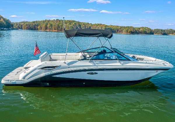 Slide: The Image of 2021 Sea Ray SDX 250 boat on a serene lake with clear skies. - 3