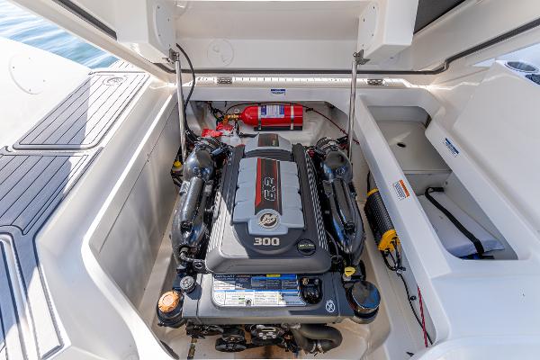 Slide: The Image of 2021 Sea Ray SDX 250 engine compartment with 300 HP engine and fire extinguisher. - 30
