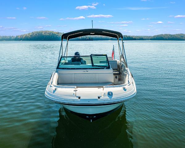 Slide: The Image of 2021 Sea Ray SDX 250 boat on calm lake with clear blue sky. - 4