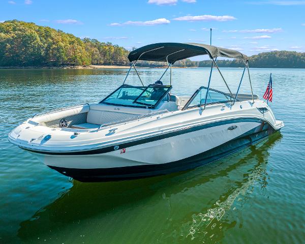 Slide: The Image of 2021 Sea Ray SDX 250 boat on a serene lake with clear skies. - 5