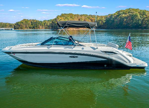 Slide: The Image of 2021 Sea Ray SDX 250 boat on a serene lake with lush green surroundings. - 6