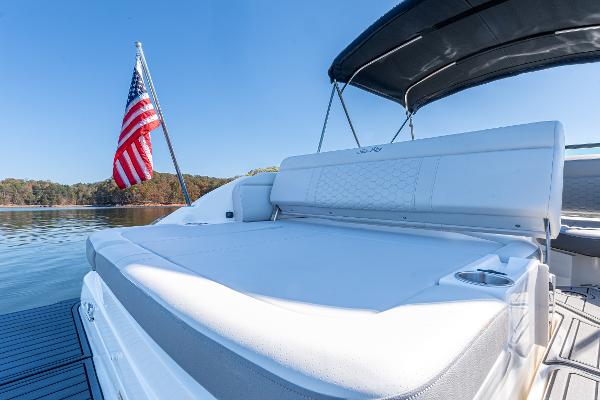 Slide: The Image of 2021 Sea Ray SDX 250 boat with American flag on calm water. - 9