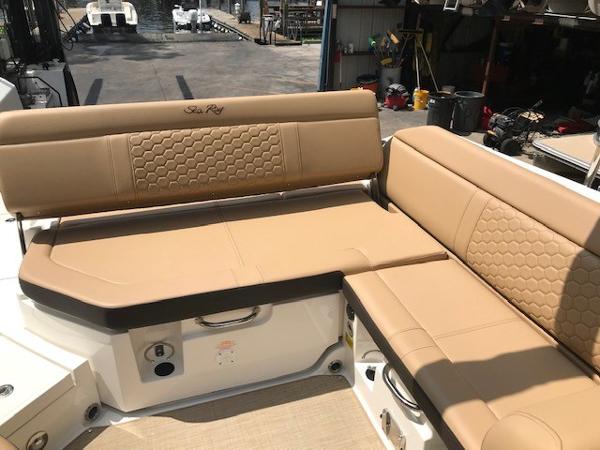 Slide: The Image of 2025 Sea Ray SDX 250 boat with tan leather seating in a marina setting. - 10
