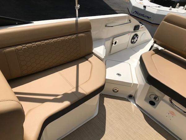 Slide: The Image of 2025 Sea Ray SDX 250 boat interior with tan seating and modern design. - 11