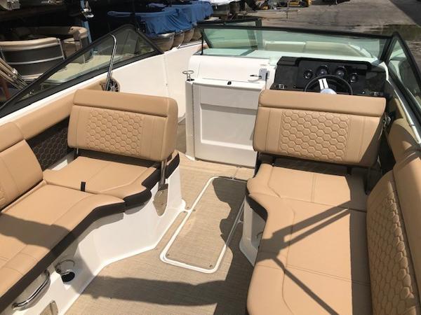 Slide: The Image of 2025 Sea Ray SDX 250 boat interior with tan seating and modern dashboard. - 14